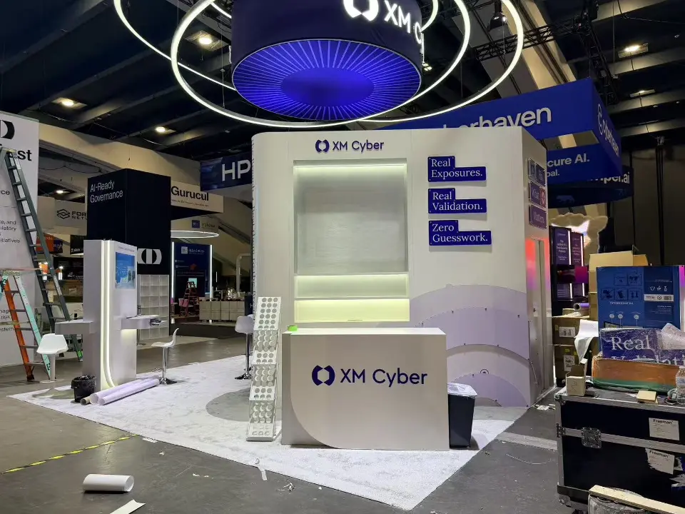 White XM Cyber counter and lit wall niche beneath the round hanging sign