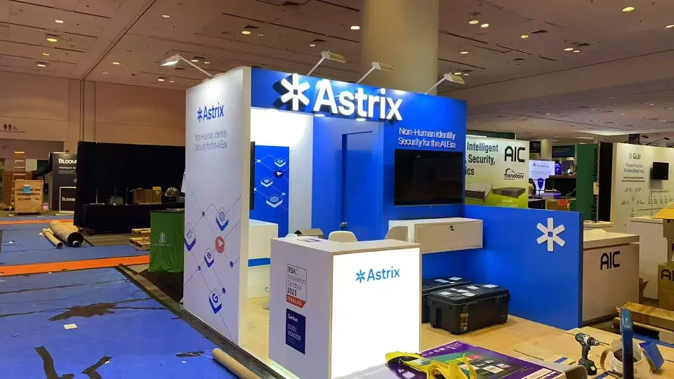 Wider corner angle of the Astrix stand with blue fascia, illuminated logo and white end wall