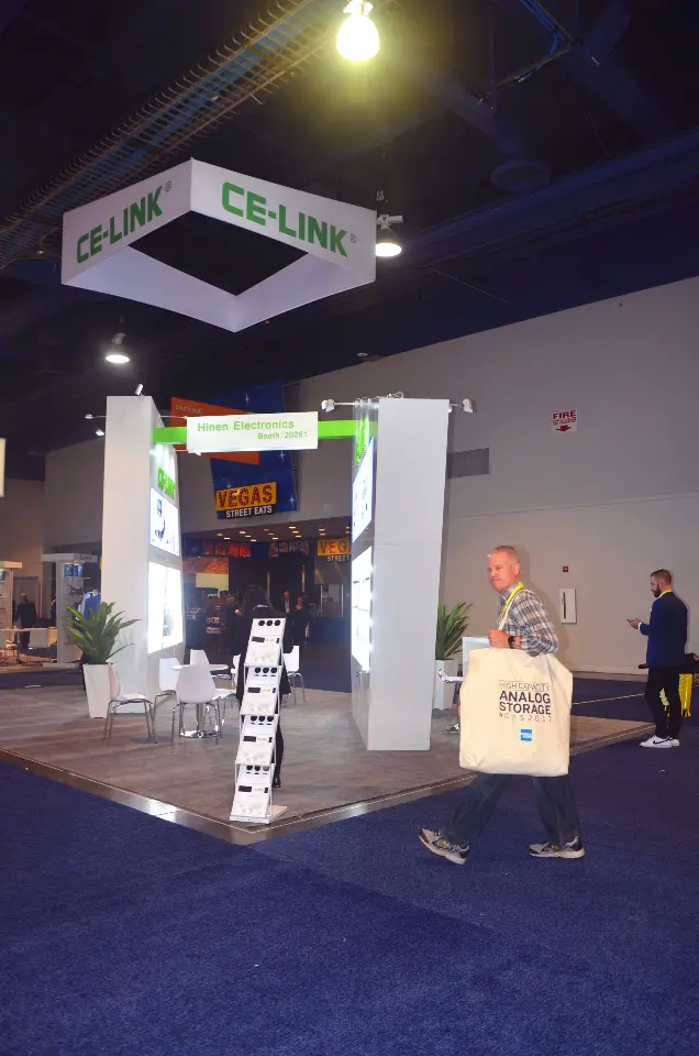 Portrait view of visitors under the CE-LINK hanging sign