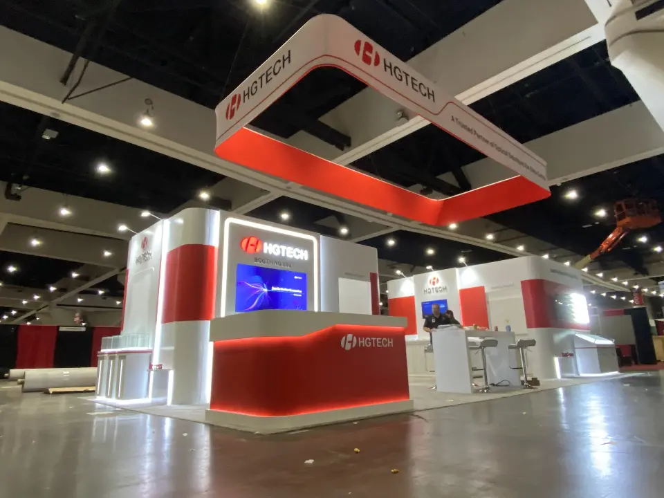 Booth corner with a red-banded tower and a screen