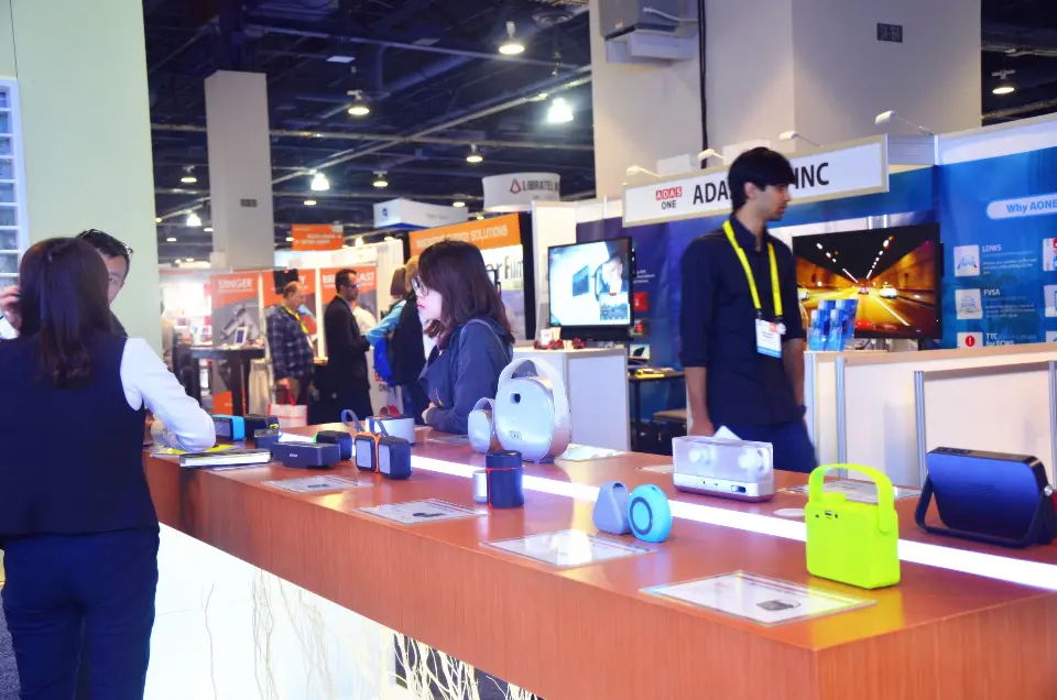 Visitors along the counter with products set out toward the aisle