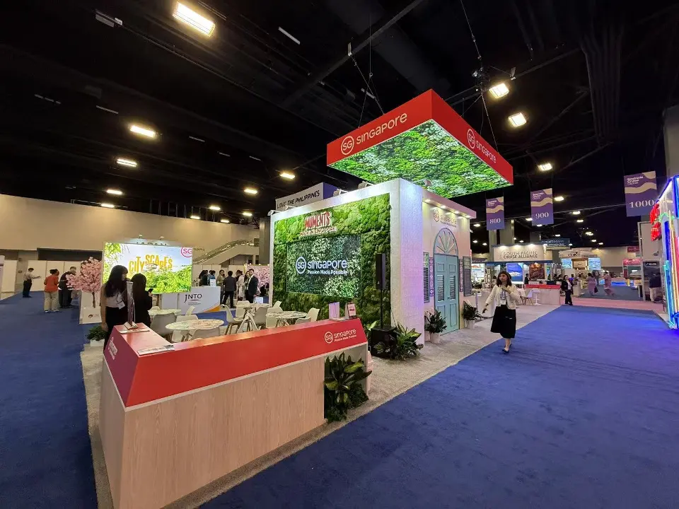 Red counter and planters along the stand edge on blue carpet