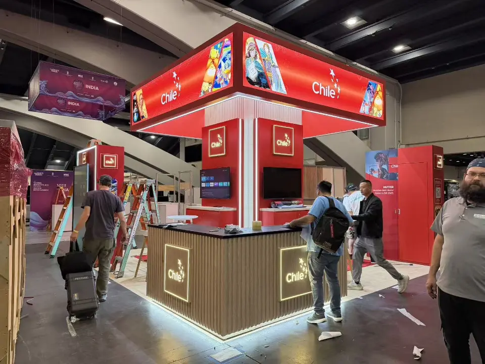 Side view with visitors at a counter under the red header and screen column