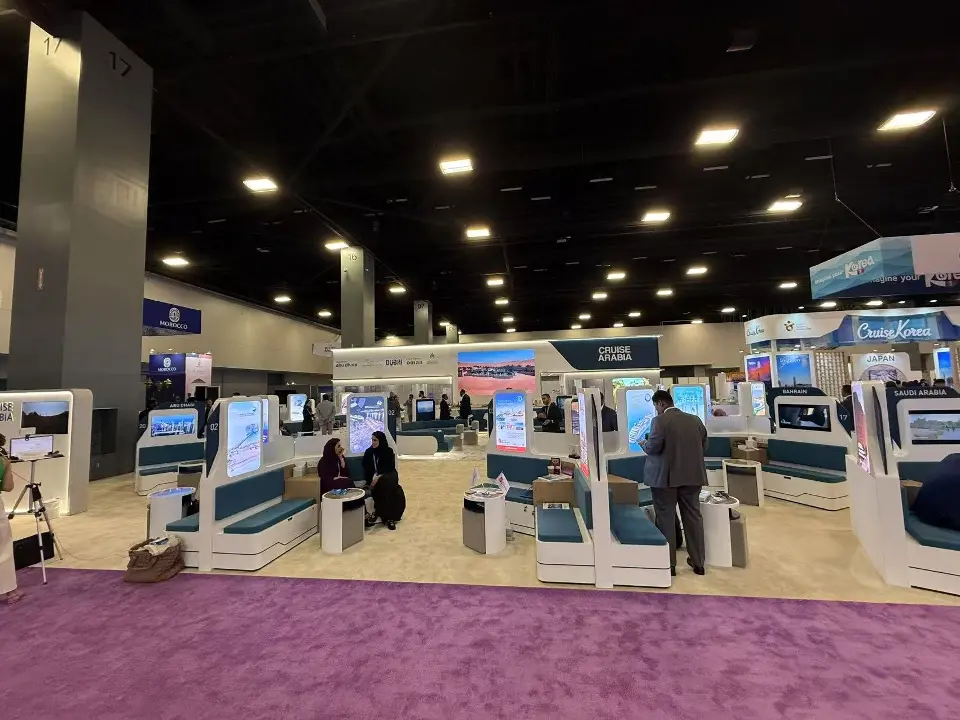 Wide view of seating pods and backlit columns across the open booth