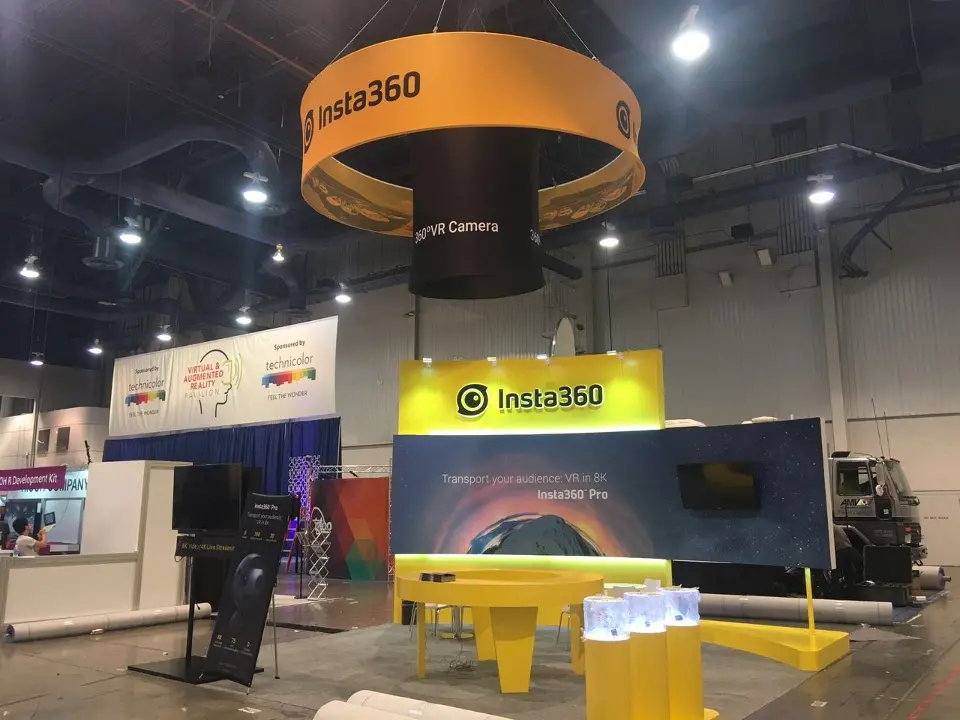 Wider front angle of the yellow Insta360 counter with clear product boxes and the hanging ring