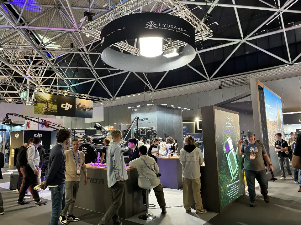 Wide view of the busy booth with ring sign and display tables