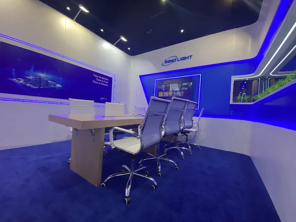 Second meeting room with a white table, chairs and blue graphic band