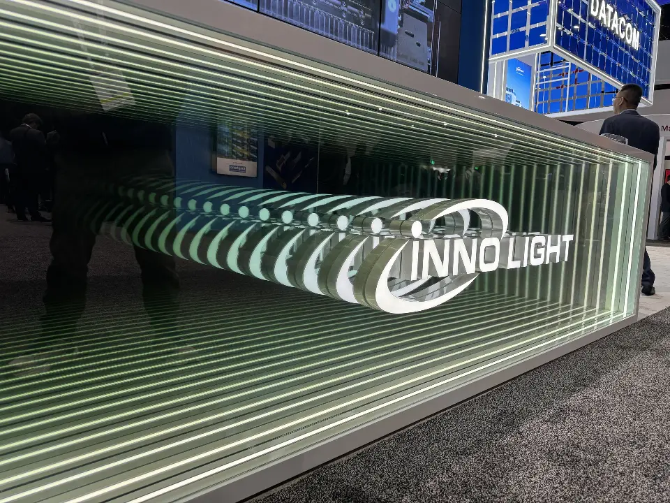 Angled view of the mirror-tunnel logo panel at floor level