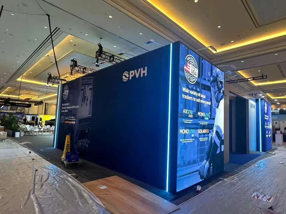 During build-up: navy PVH wall with backlit panels while the carpet is still under plastic