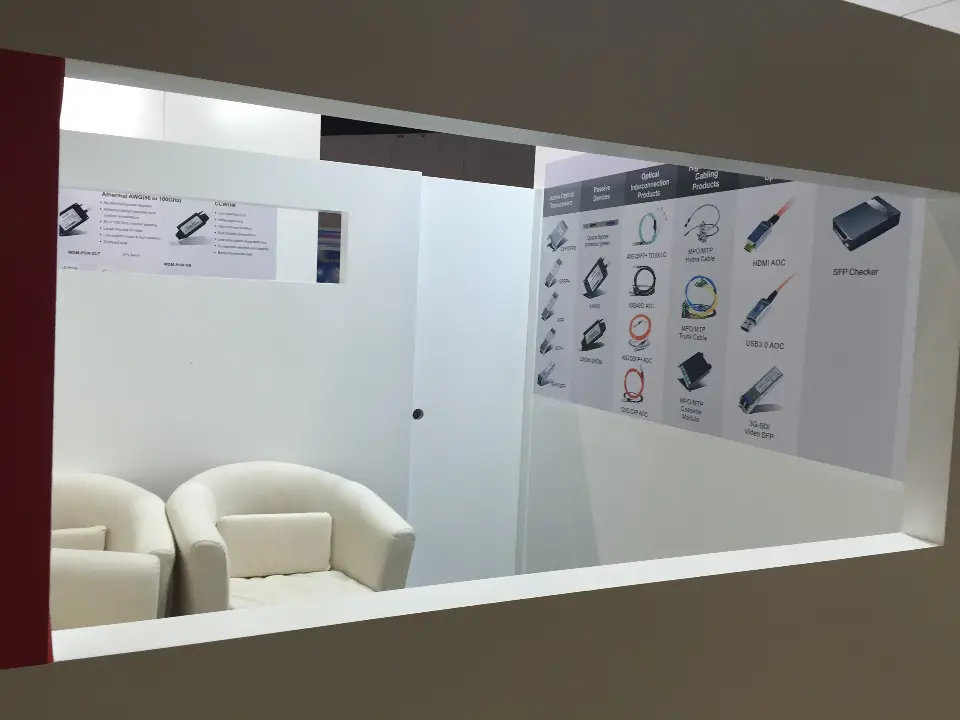 Lounge room interior with white armchairs and product display shelving