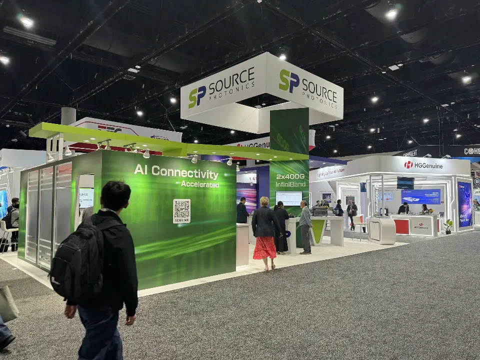 Green AI Connectivity wall corner under a white SOURCE hanging cube sign