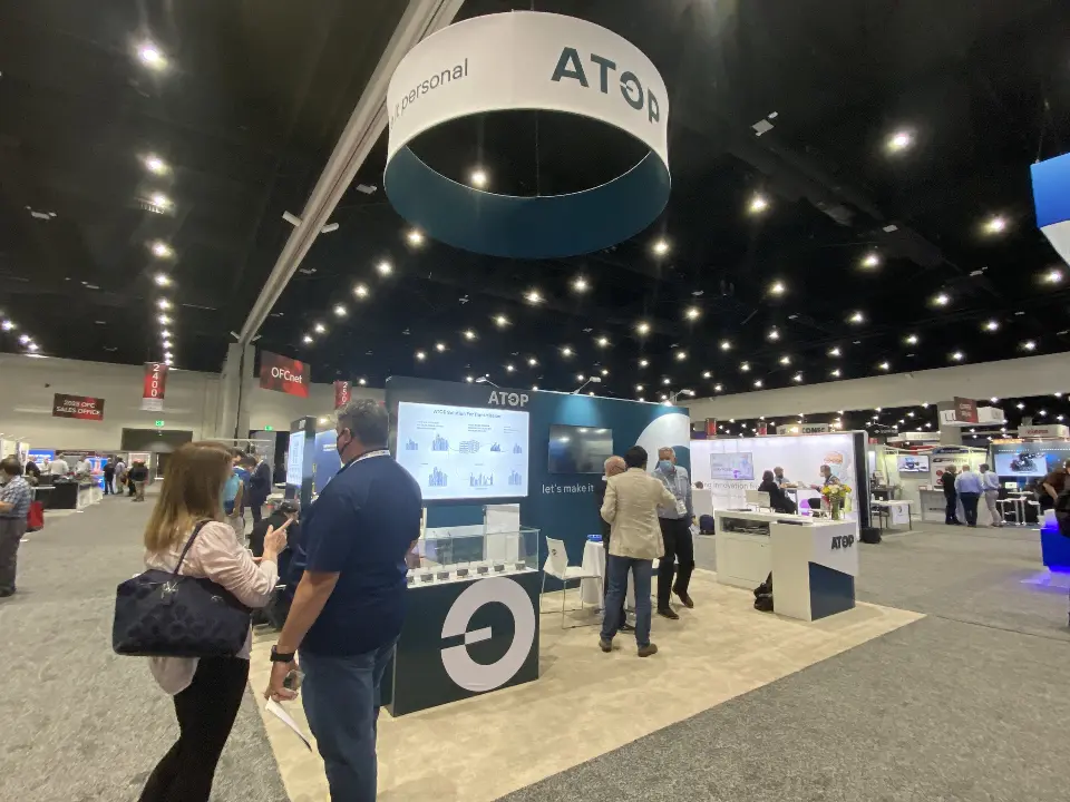 Side angle of the finished booth showing the logo wall and display tower