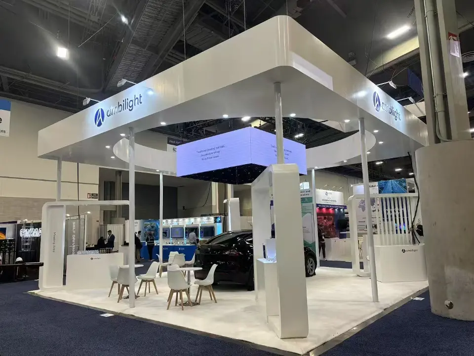 Ambilight stand from the opposite corner, showing white columns, lounge chairs and a dark car beneath the canopy