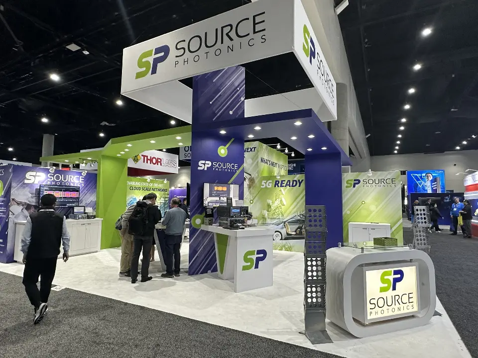 Front with the hanging SP header, demo counter and visitors at screens