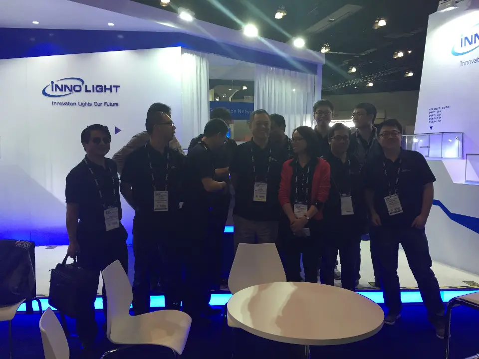 Team photo in front of the InnoLight wall with blue floor lighting