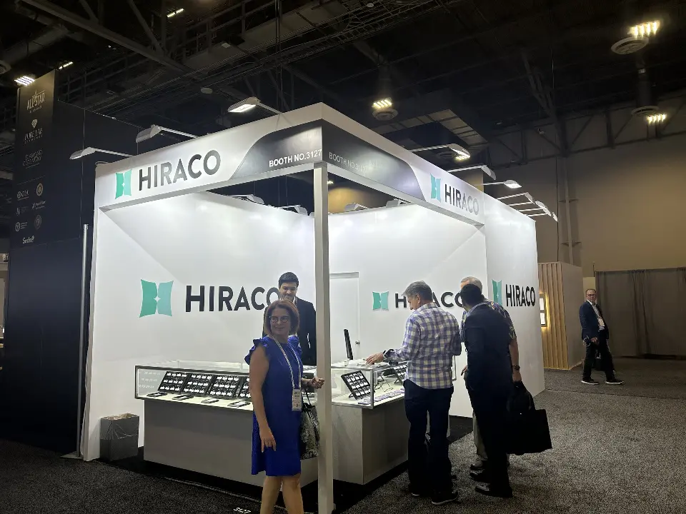 Visitors at the glass showcases with HIRACO logos behind