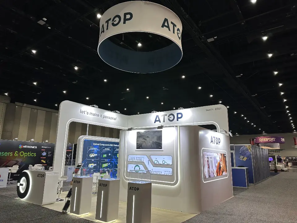 Front view of the ATOP booth with lit counters, product shelves and ring sign above