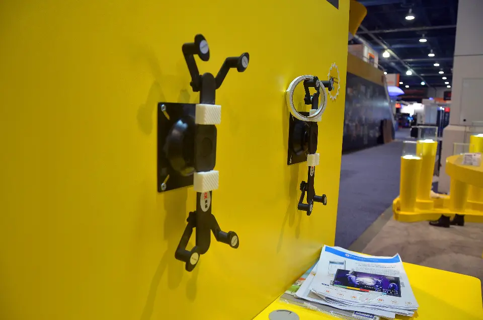 Close-up of camera mounts displayed on the yellow Insta360 wall