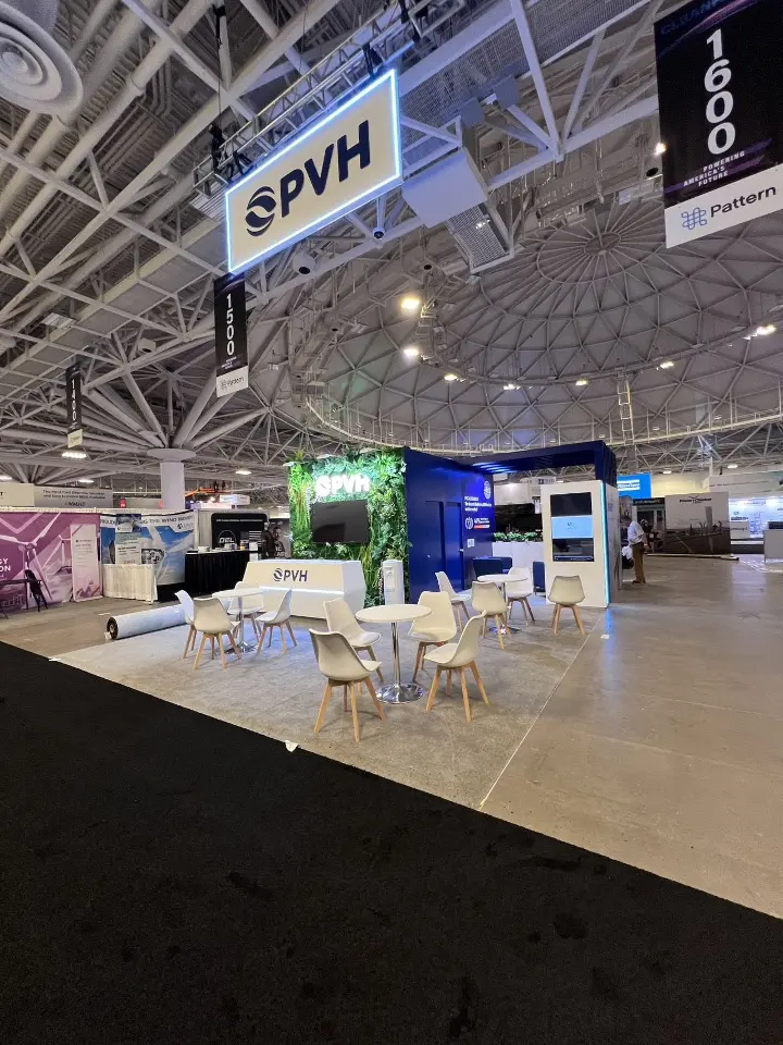 Wide view from the aisle with the square PVH hanging sign above the meeting area