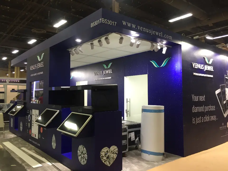 Corner view of the navy booth with touchscreens, spotlights and website fascia