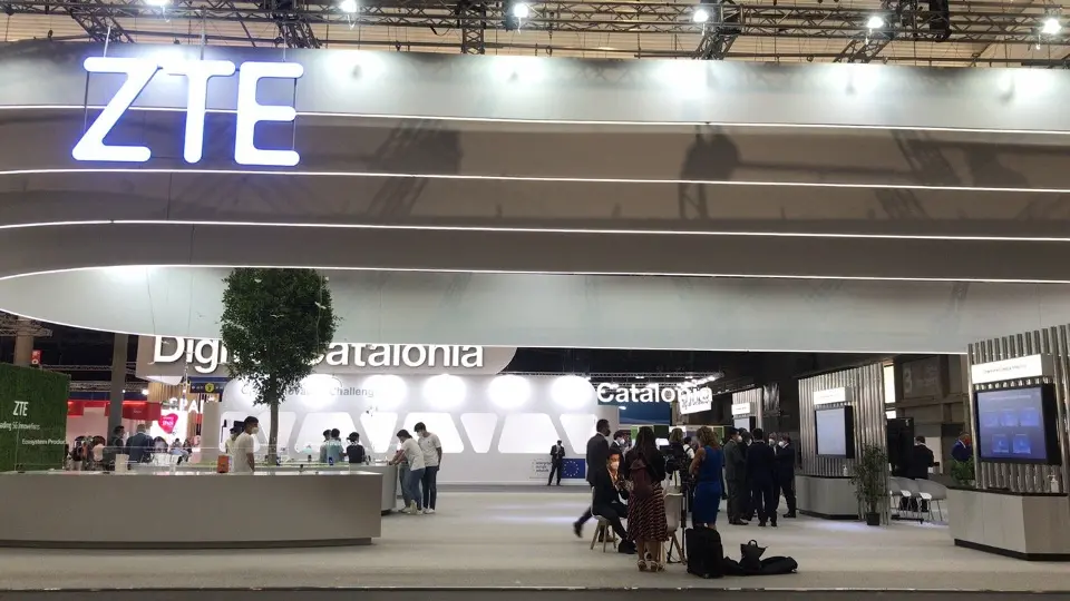 Glowing ZTE logo over a counter and display area on the open floor