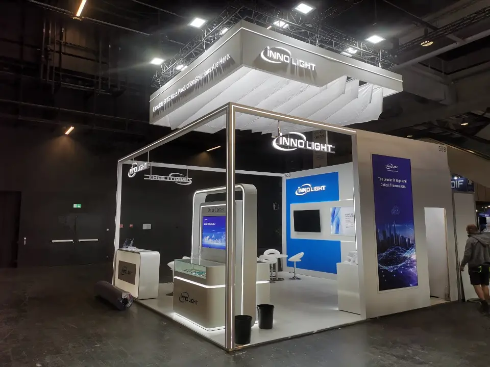 InnoLight corner booth with lit white frame, suspended fabric canopy, Data Center kiosk and blue feature wall
