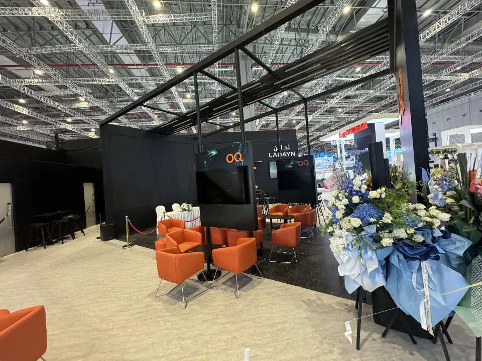 Orange armchairs arranged in the lounge under the black overhead frame
