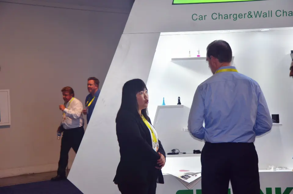 Car charger and wall charger shelves with visitors in conversation