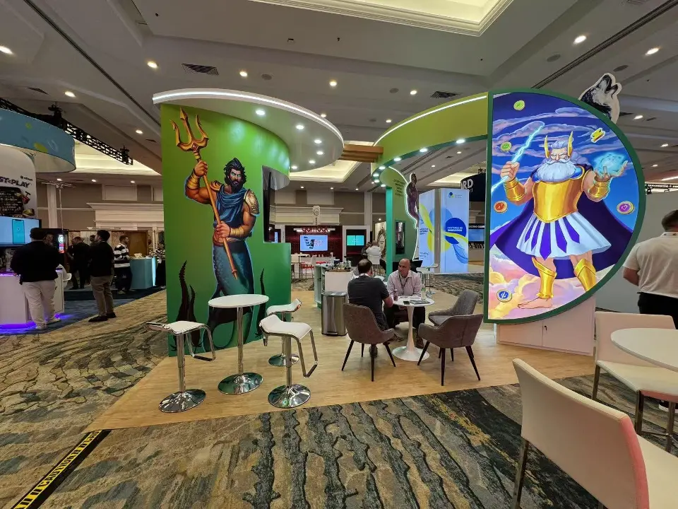 Sea god with a trident on a green tower beside the thunder god panel and grey lounge chairs