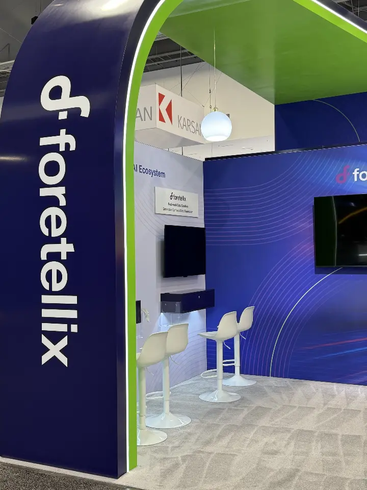 Tall arched column with vertical Foretellix logo beside demo stations