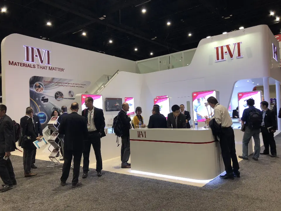 Crowd around the front counter with backlit pink panels behind