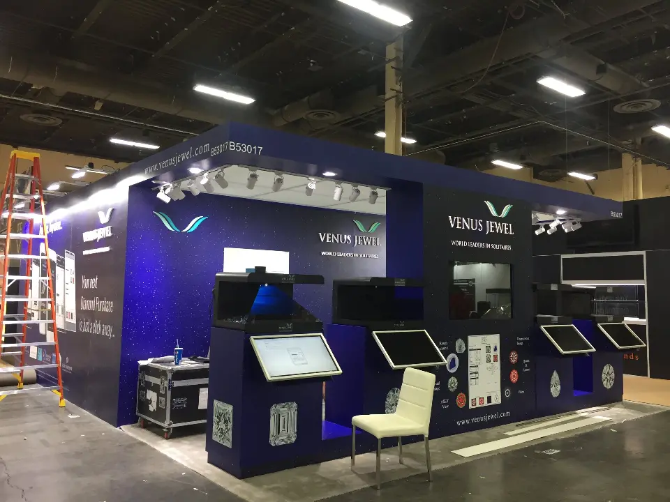 Front of the navy booth with angled touchscreen kiosks and diamond graphics