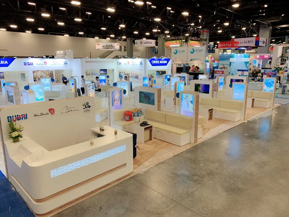 Curved white counter with a flower arrangement at the booth front