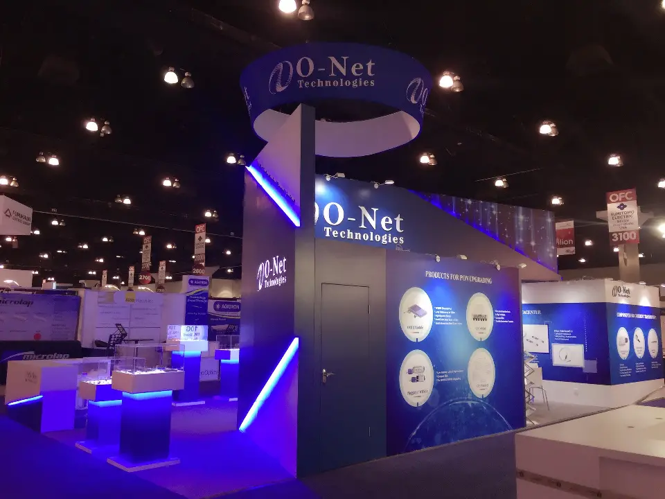 Booth interior with navy column, lit showcases and blue glow across the floor