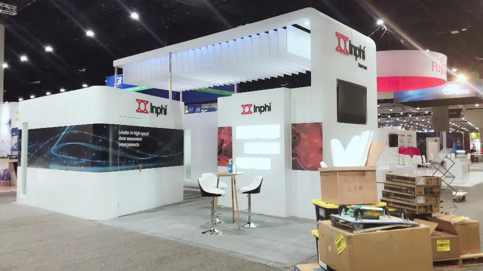 Inphi booth front with bar stools, high table and dark graphic band on the meeting room