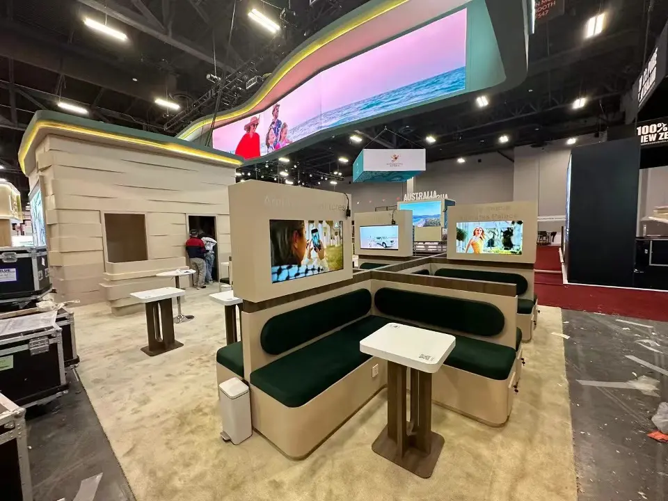 Green banquette booth with a white table inside the Abu Dhabi pavilion