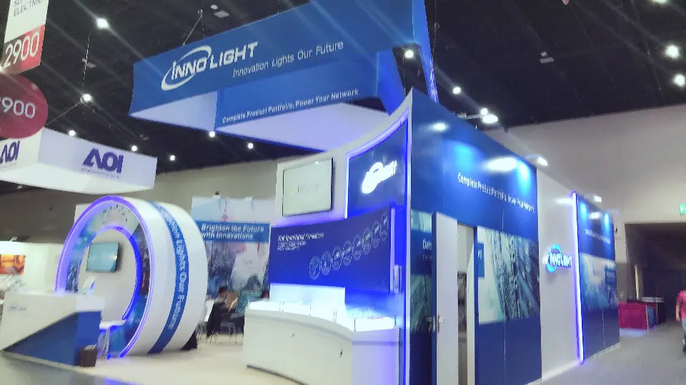 Corner view of the blue booth with ring arch, lit edges and hanging sign