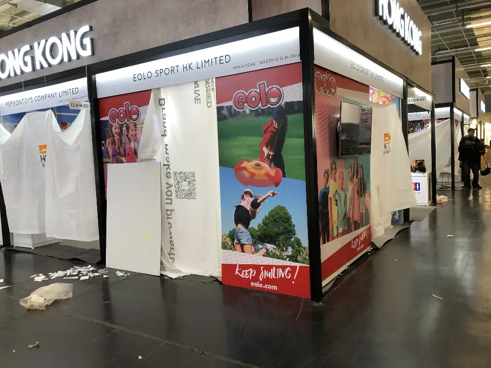 Same corner booth from another angle showing red and white sports graphics