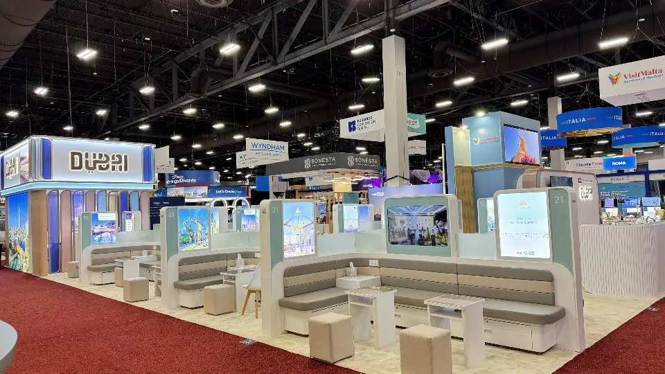 Long run of white seating pods with backlit city graphics on red carpet