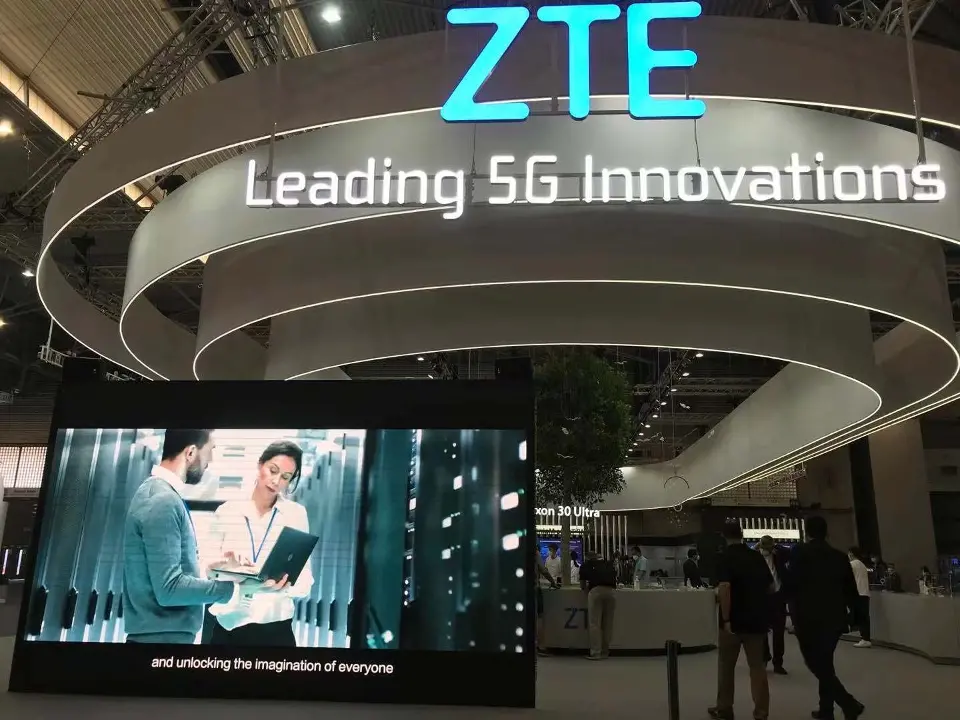 Lit ZTE sign and Leading 5G Innovations text above a video screen