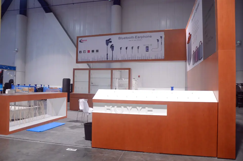 Long low view of the lit display counter along the front of the booth