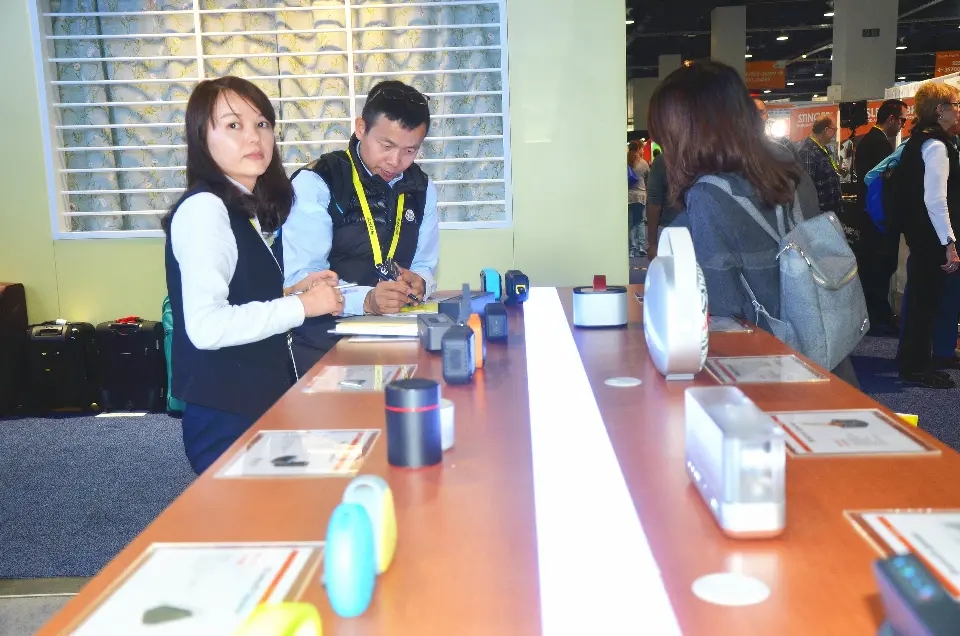 Staff seated with visitors around products on the long counter